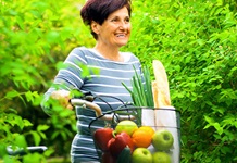 Mature female with bike and fruit
