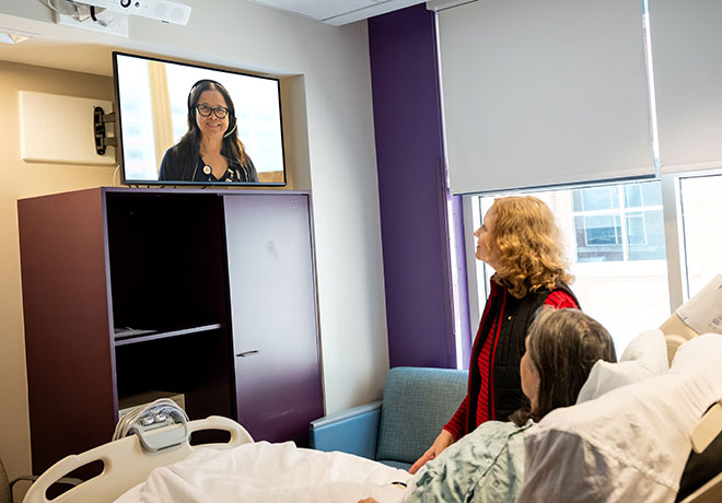 a patient and family member seeing a nurse through virtual visit